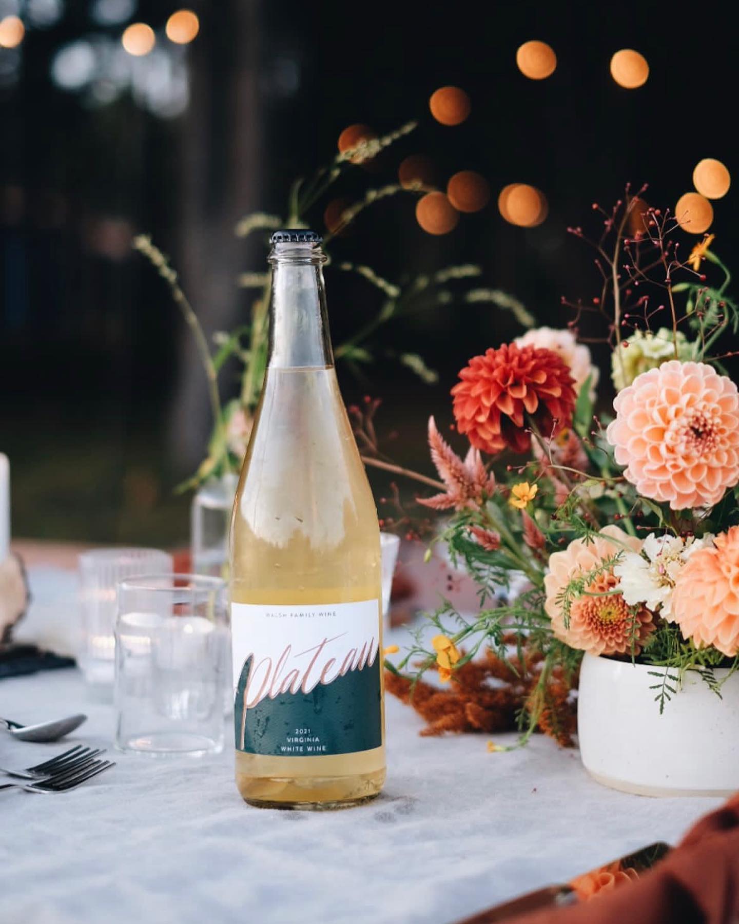 Bottle of Plateau sparkling wine on a formal dinner table